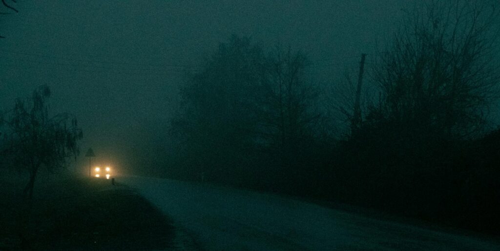 Headlights on Road in Fog at Night